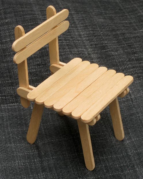 Popsicle stick house with table and chairs
